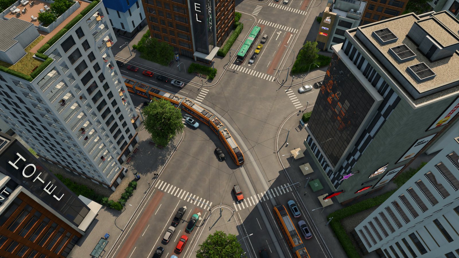 The same downtown crossroads with orange trams curving through it on tracks, red bus lanes, a green bus and far fewer cars